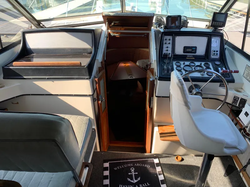 Slide: The Image of Interior of 1986 Carver 28 Riviera boat with steering wheel and control panel. - 3