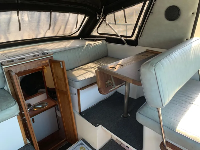 Slide: The Image of Interior of 1986 Carver 28 Riviera boat with seating and small kitchenette. - 5