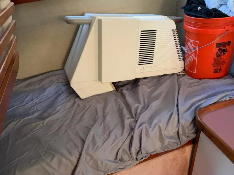 Slide: The Image of 1986 Carver 28 Riviera interior with air conditioning unit and orange bucket. - 8