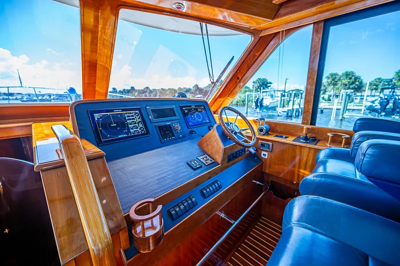 Slide: The Image of Helm of 2005 Hinckley Talaria 55 MY yacht with wooden dashboard and leather seating. - 10