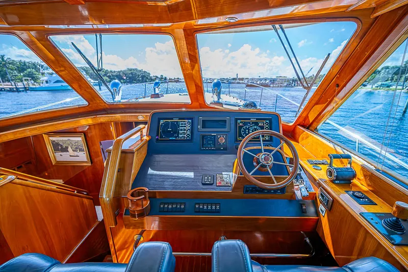 Slide: The Image of Helm of 2005 Hinckley Talaria 55 MY yacht with wooden interior and scenic ocean view. - 13