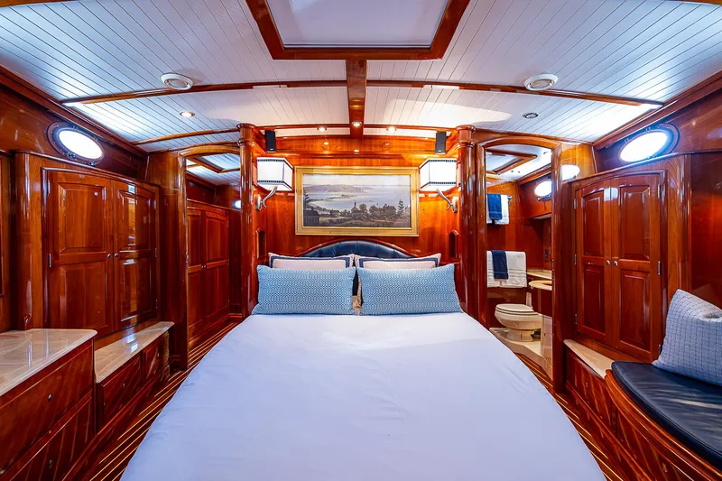 Slide: The Image of Luxurious 2005 Hinckley Talaria 55 MY yacht cabin with elegant wood finish and cozy bedding. - 21