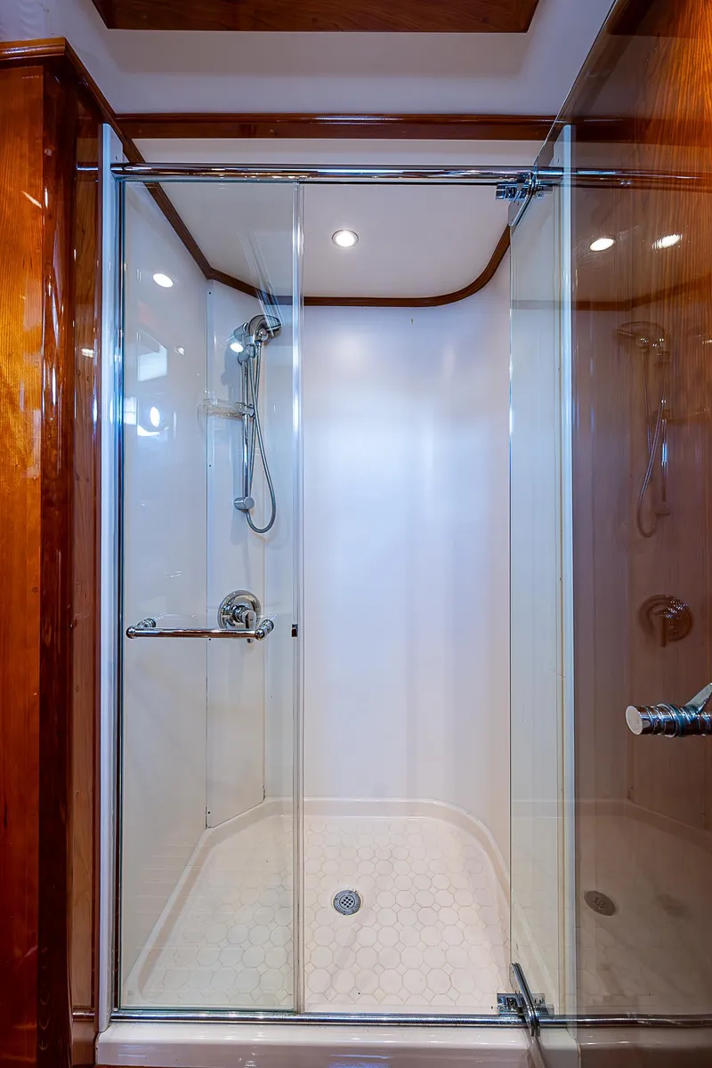 Slide: The Image of Luxurious shower in 2005 Hinckley Talaria 55 MY yacht with glass doors and wooden accents. - 25