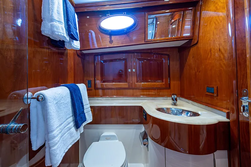 Slide: The Image of Luxurious 2005 Hinckley Talaria 55 MY yacht bathroom with wood cabinetry and modern fixtures. - 27