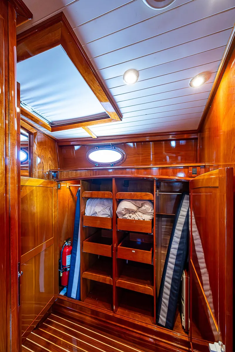 Slide: The Image of Luxurious wooden interior of 2005 Hinckley Talaria 55 MY yacht with shelving and lighting. - 32