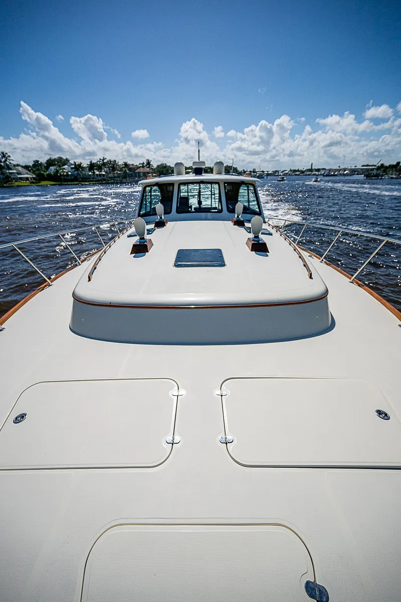 Slide: The Image of Hinckley Talaria 55 MY 2005 yacht cruising on open water under a clear blue sky. - 36