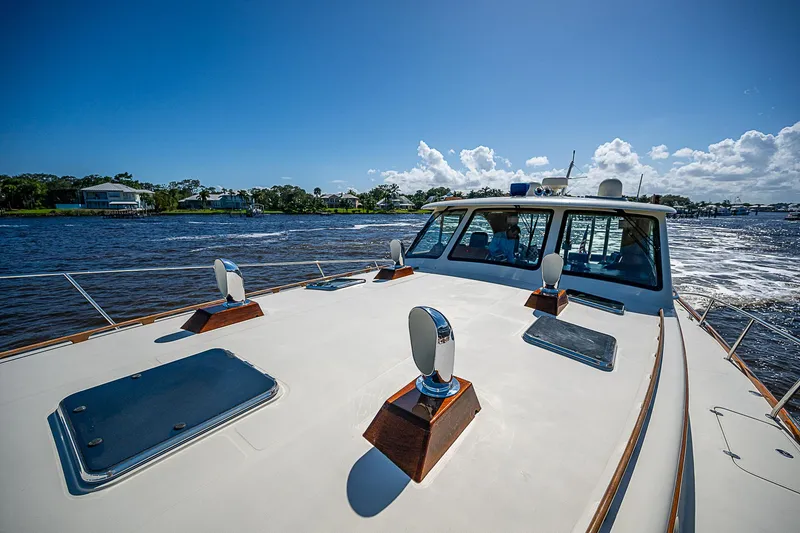 Slide: The Image of Hinckley Talaria 55 MY 2005 yacht cruising on a sunny day, showcasing sleek design and craftsmanship. - 37