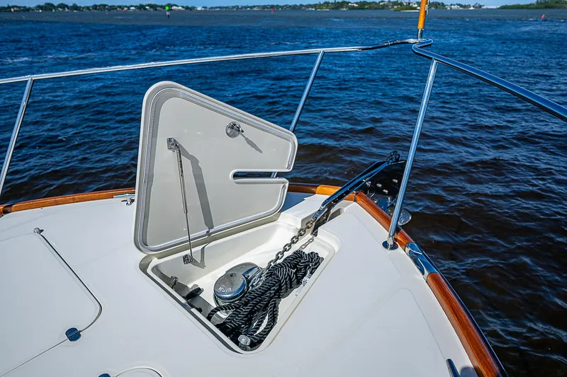 Slide: The Image of Open anchor hatch on 2005 Hinckley Talaria 55 MY yacht, with ropes and winch visible. - 40