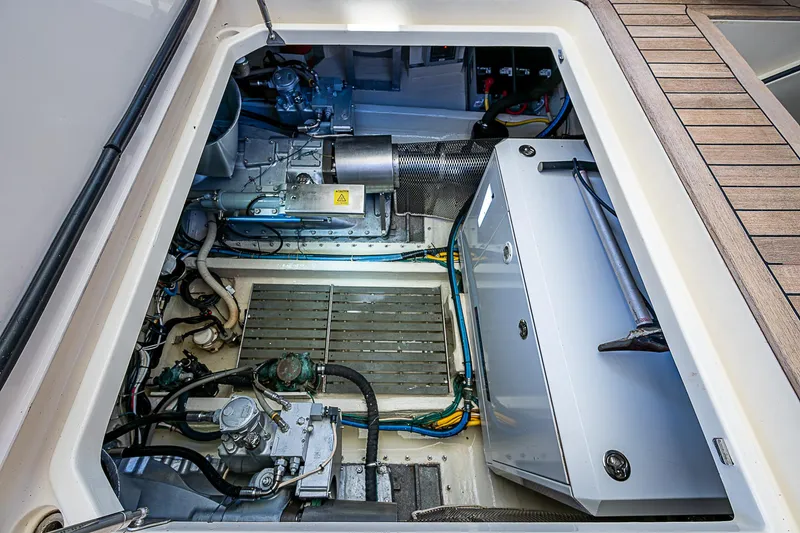 Slide: The Image of Engine compartment of 2005 Hinckley Talaria 55 MY yacht, showcasing mechanical components and systems. - 42