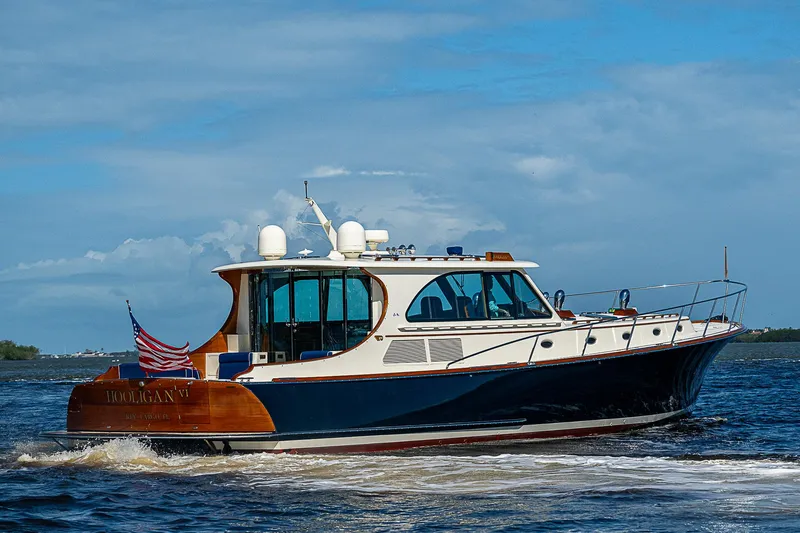 Slide: The Image of 2005 Hinckley Talaria 55 MY yacht cruising on open water under a clear blue sky. - 47