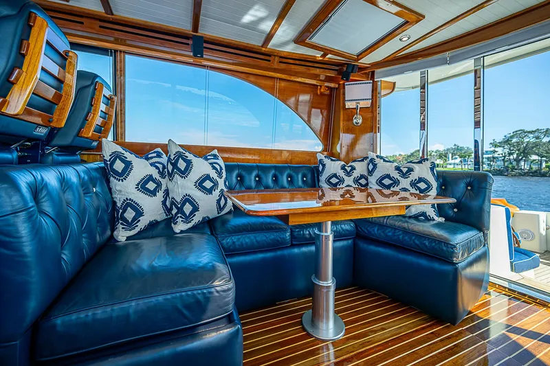 Slide: The Image of Luxurious interior of 2005 Hinckley Talaria 55 MY yacht with blue leather seating and wooden accents. - 8
