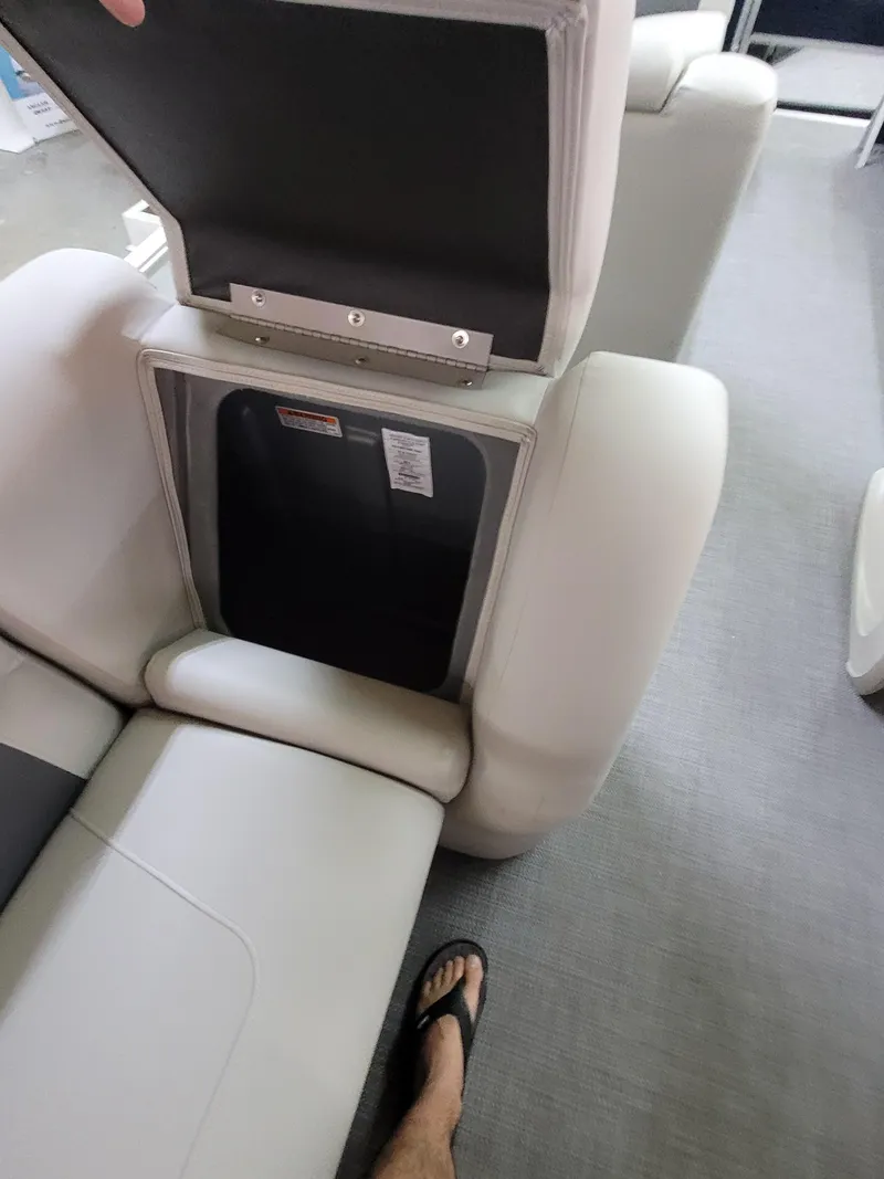 Slide: The Image of 2025 SunChaser Vista 22 Fish boat interior with open storage compartment and seating. - 11