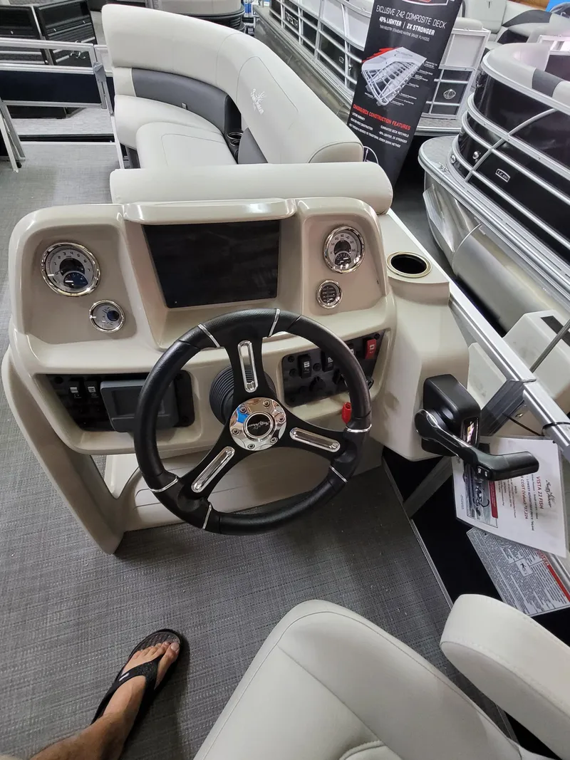 Slide: The Image of 2025 SunChaser Vista 22 Fish boat interior with steering wheel and control panel. - 7