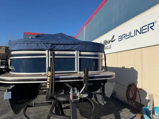 Slide: The Image of 2021 Ranger RP243C pontoon boat with blue cover at dealership. - 1