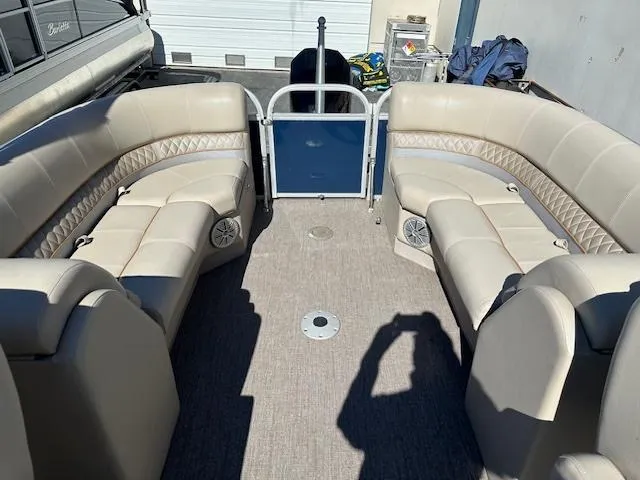 Slide: The Image of 2021 Ranger RP243C pontoon boat interior with beige seating and carpeted floor. - 7