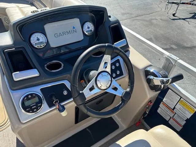 Slide: The Image of 2021 Ranger RP243C boat dashboard with Garmin navigation system and steering wheel. - 8