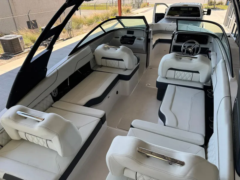 Slide: The Image of 2022 Regal LX2 boat interior with luxurious white seating and modern dashboard. - 12