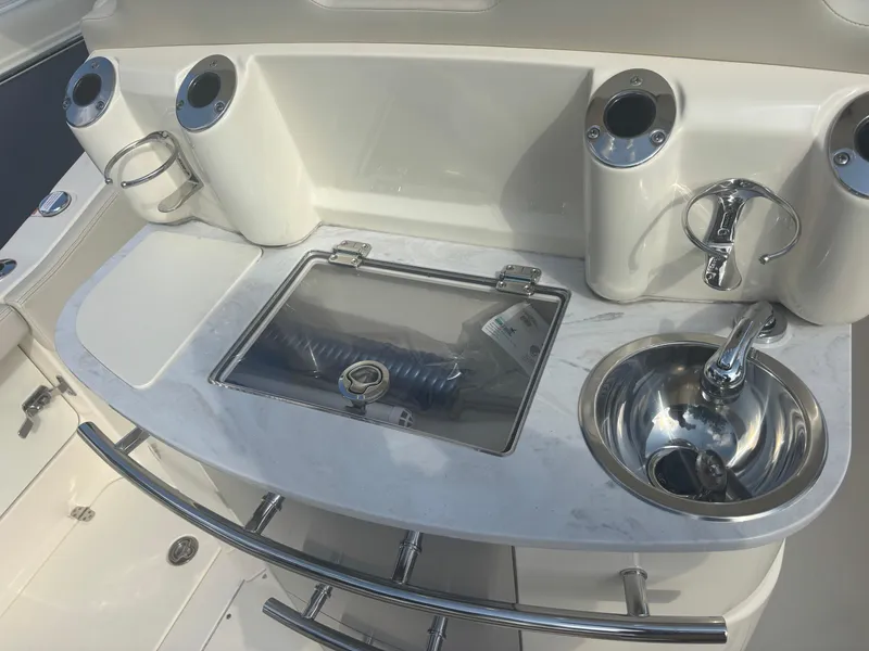 Slide: The Image of 2025 Scout 277 LXF boat interior with sink and storage compartments. - 10