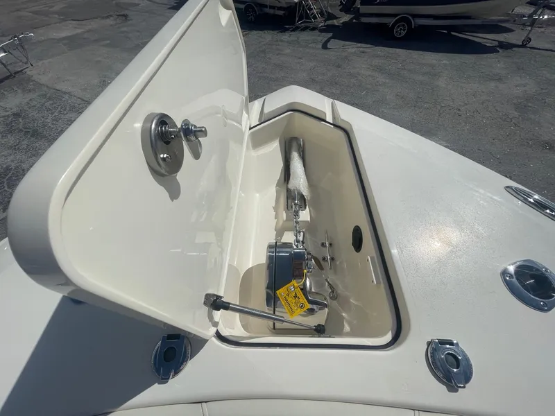 Slide: The Image of 2025 Scout 277 LXF boat anchor compartment with open hatch. - 7