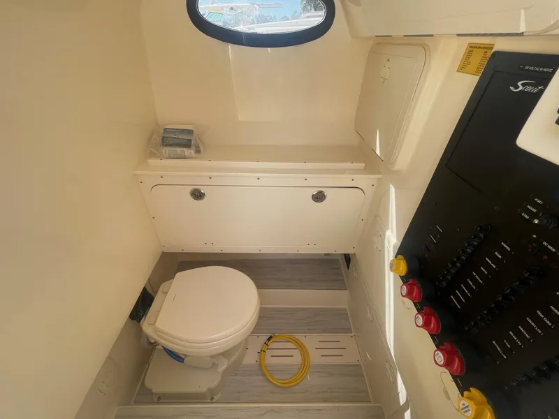 Slide: The Image of 2025 Scout 277 LXF boat interior with toilet and control panel. - 8