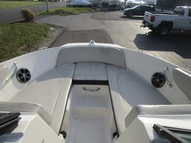 Slide: The Image of 2021 Sea Ray 210 SPX boat interior with white seating and speakers. - 11