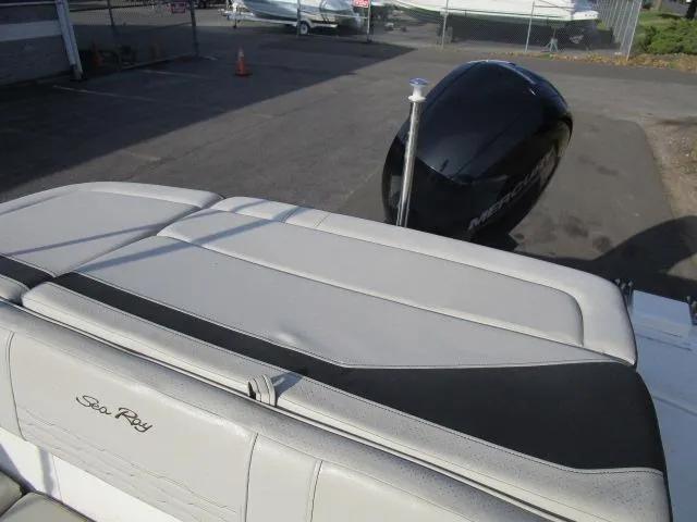 Slide: The Image of 2021 Sea Ray 210 SPX boat with sleek seating and powerful outboard motor. - 13