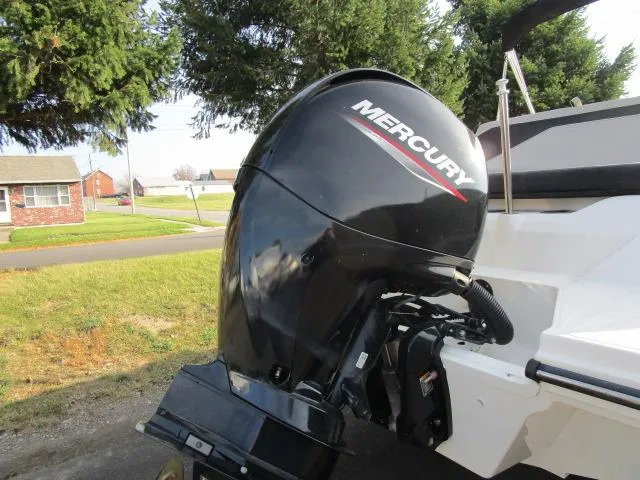 Slide: The Image of 2021 Sea Ray 210 SPX with Mercury outboard motor, parked outdoors. - 15
