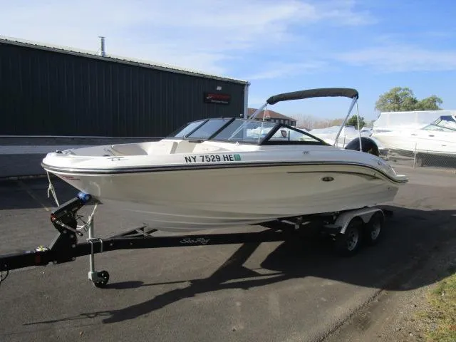 Slide: The Image of 2021 Sea Ray 210 SPX boat on trailer, parked outdoors. - 2