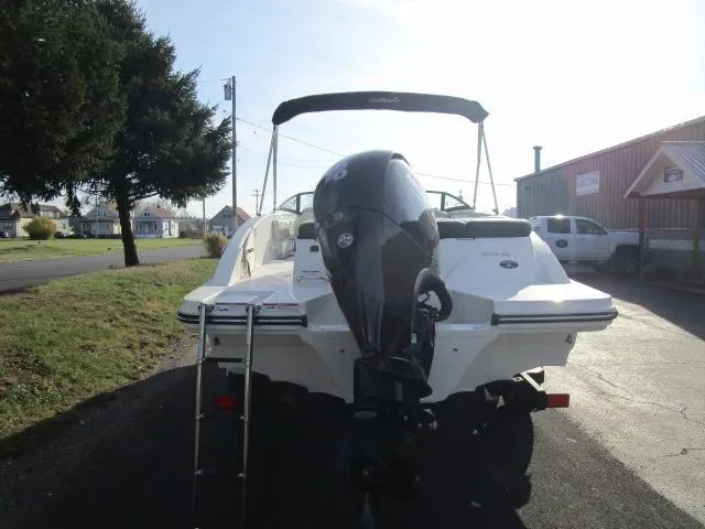 Slide: The Image of 2021 Sea Ray 210 SPX boat with outboard motor, parked outdoors. - 3