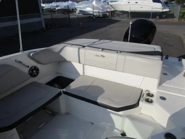 Slide: The Image of 2021 Sea Ray 210 SPX boat interior with cushioned seating and storage compartments. - 5