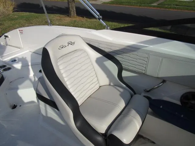 Slide: The Image of 2021 Sea Ray 210 SPX boat interior with white and black seating. - 8