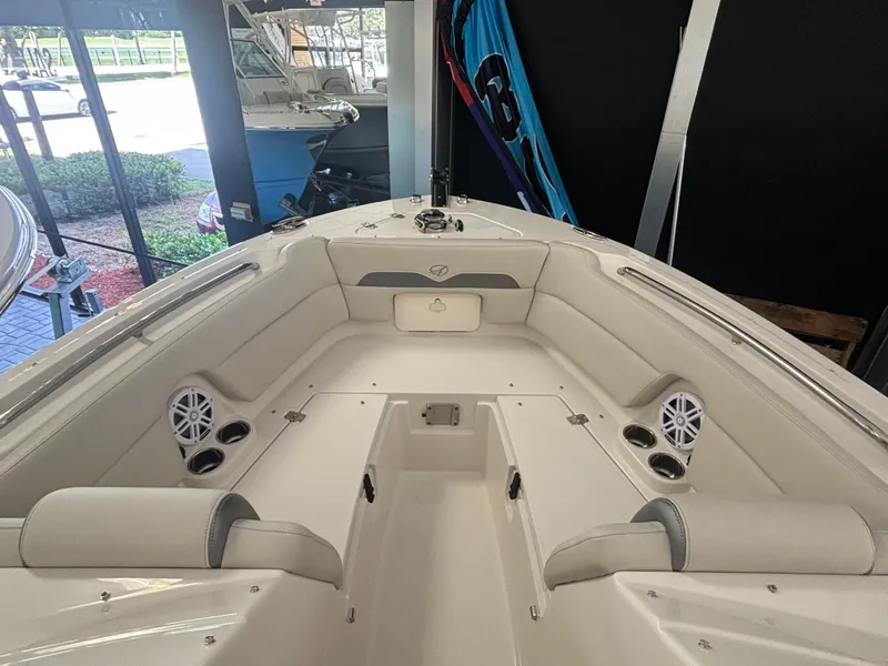 Slide: The Image of 2025 Sailfish 245 DC boat interior with cushioned seating and built-in speakers. - 11