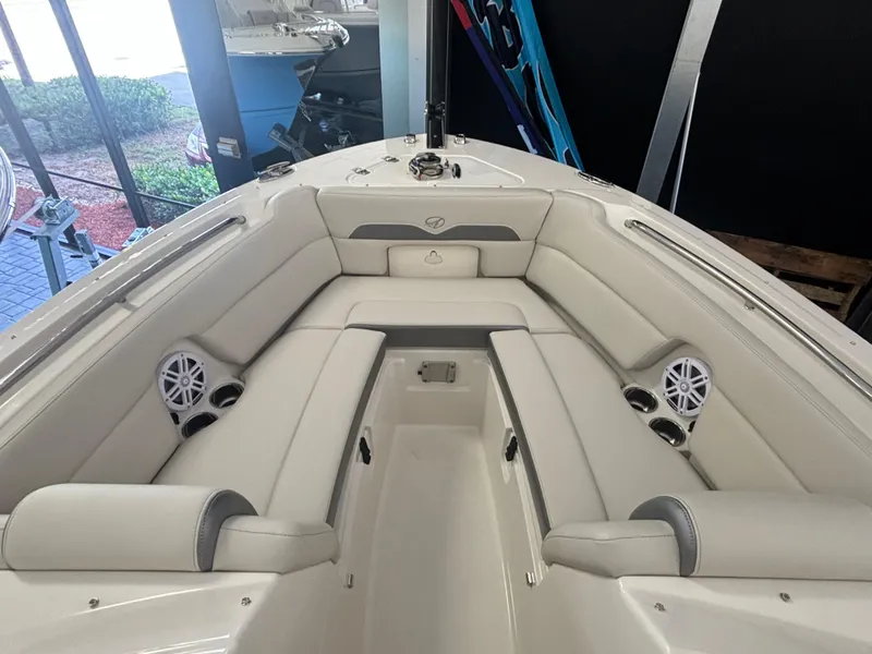 Slide: The Image of 2025 Sailfish 245 DC boat interior with white seating and cup holders. - 12