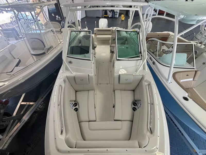 Slide: The Image of 2025 Sailfish 245 DC boat interior with white seating and modern design. - 13