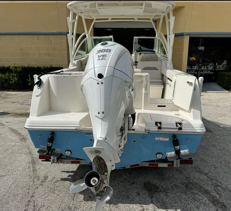 Slide: The Image of 2025 Sailfish 245 DC boat with powerful 300 V6 engine, parked outdoors. - 3