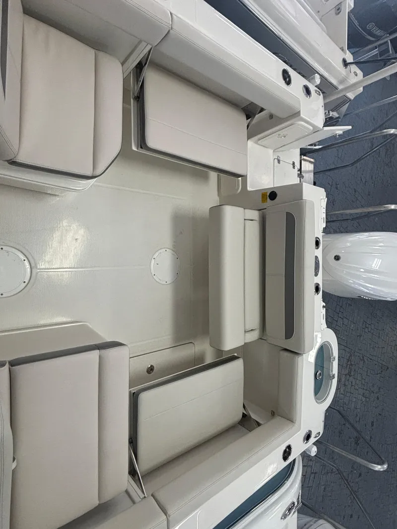 Slide: The Image of 2025 Sailfish 245 DC boat interior with cushioned seating and modern design. - 5