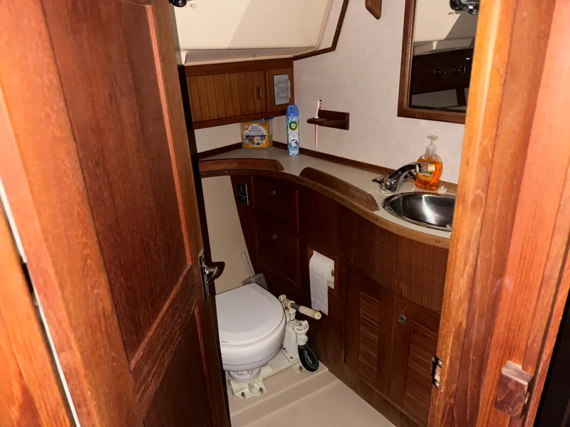 Slide: The Image of 1997 Island Packet 350 yacht bathroom with wooden cabinetry and compact design. - 21