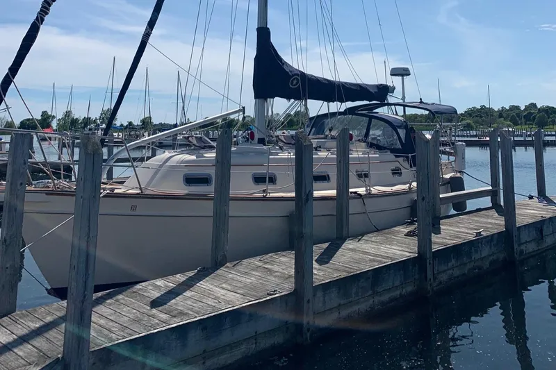 Slide: The Image of 1997 Island Packet 350 sailboat docked at a marina on a sunny day. - 3