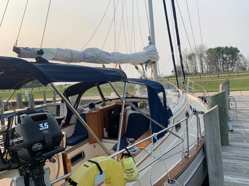 Slide: The Image of 1997 Island Packet 350 sailboat docked with Tohatsu outboard motor. - 4