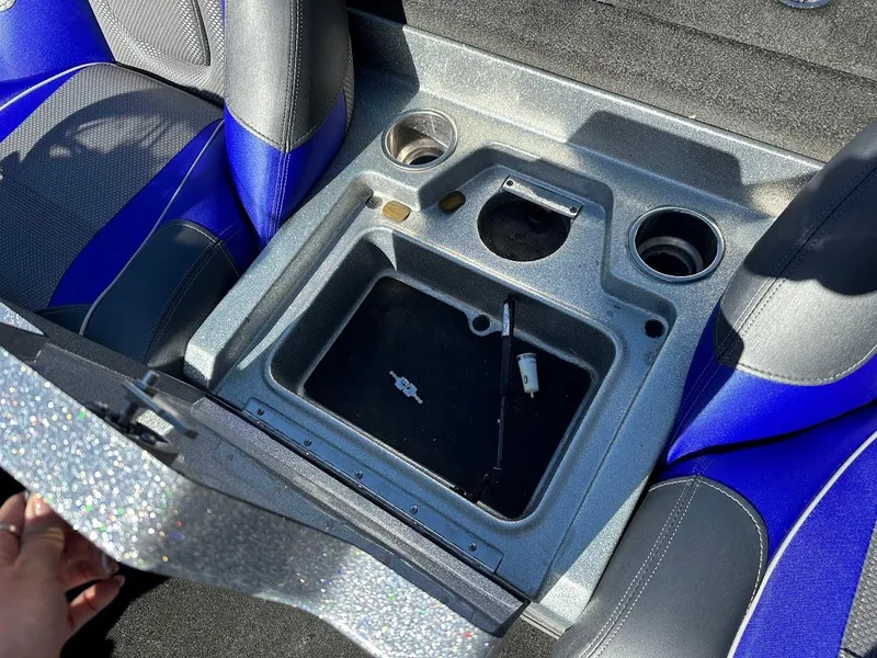 Slide: The Image of 2017 Ranger Z518 boat storage compartment with cup holders and blue-gray seating. - 23
