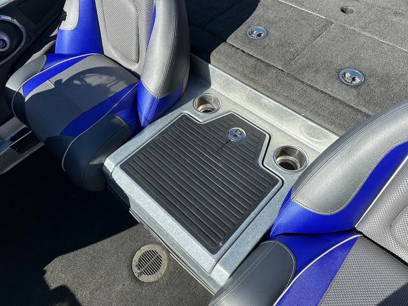 Slide: The Image of 2017 Ranger Z518 boat interior with blue and gray seats and storage area. - 24