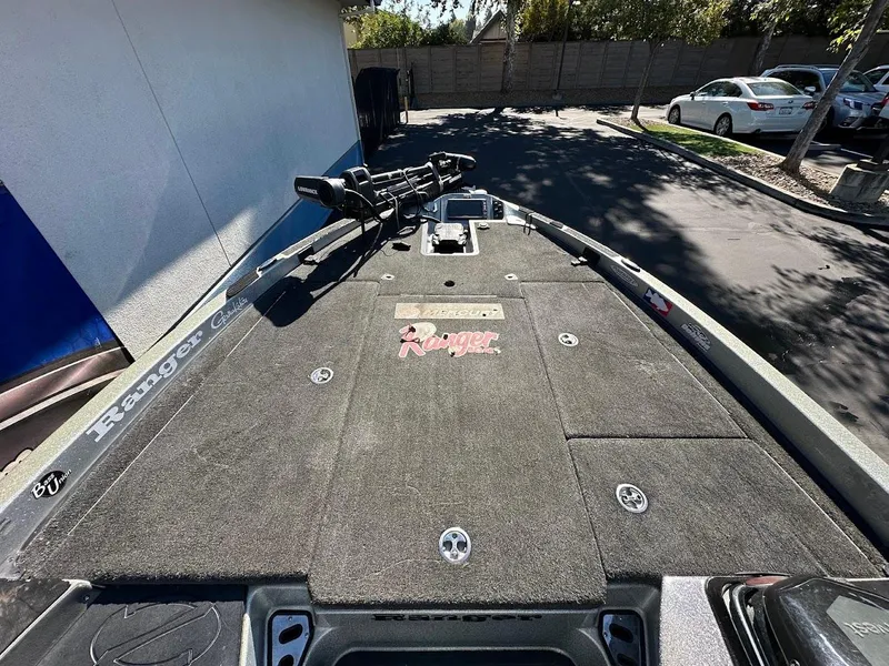 Slide: The Image of 2017 Ranger Z518 boat deck with fishing equipment, parked outdoors. - 28
