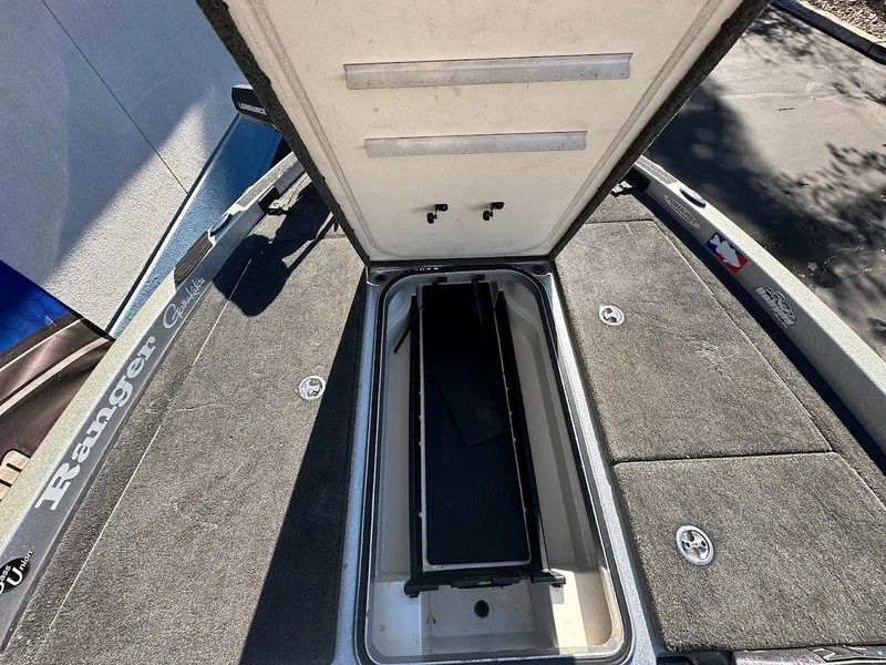 Slide: The Image of 2017 Ranger Z518 boat storage compartment open, showcasing interior space. - 29