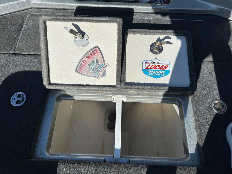 Slide: The Image of 2017 Ranger Z518 storage compartment with stickers, open lid, and carpeted interior. - 37