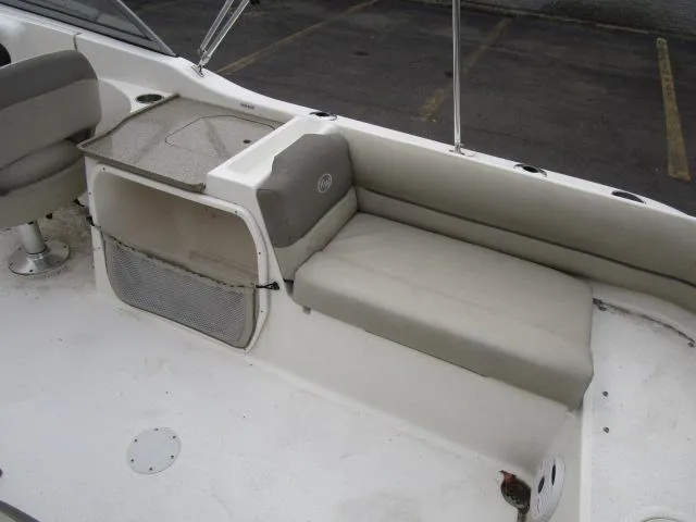 Slide: The Image of 2022 Key West 239 DFS boat interior with cushioned seating and storage. - 12