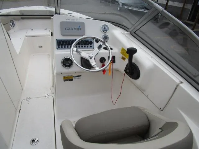Slide: The Image of 2022 Key West 239 DFS boat cockpit with Garmin navigation system and steering wheel. - 13