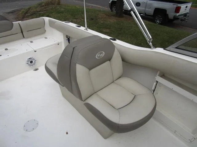 Slide: The Image of 2022 Key West 239 DFS boat interior with beige seating and speaker. - 14