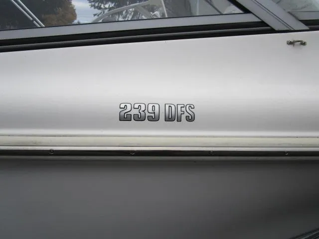 Slide: The Image of 2022 Key West 239 DFS boat side view with model name displayed. - 23