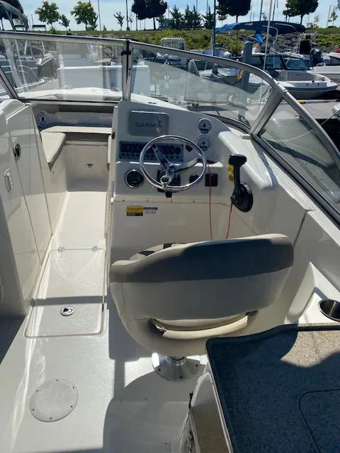 Slide: The Image of 2022 Key West 239 DFS boat interior with steering wheel and dashboard. - 5