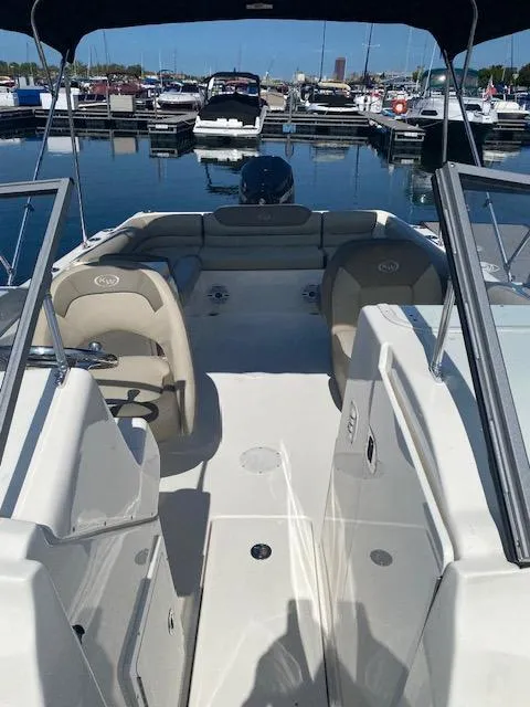 Slide: The Image of 2022 Key West 239 DFS boat interior at marina, featuring seating and helm. - 7